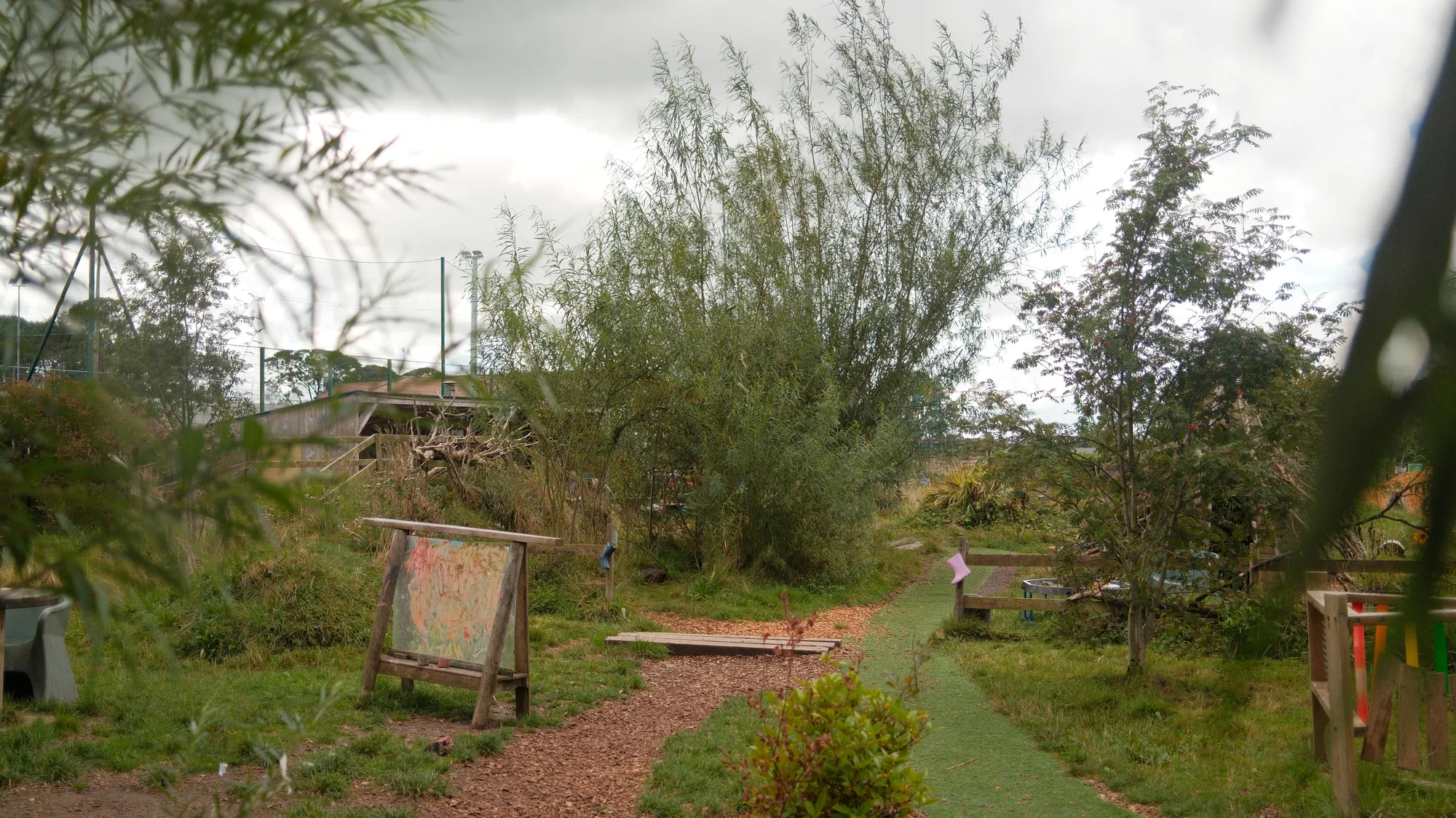 A brick path leading through the garden gate