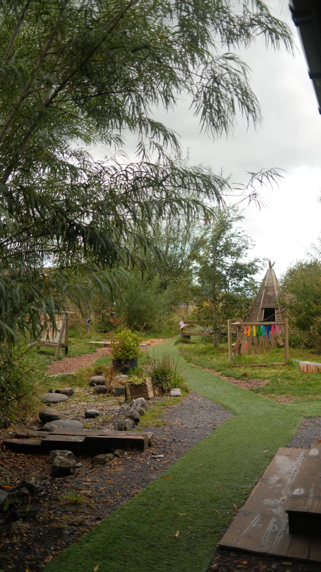 The worn green path beside the garden