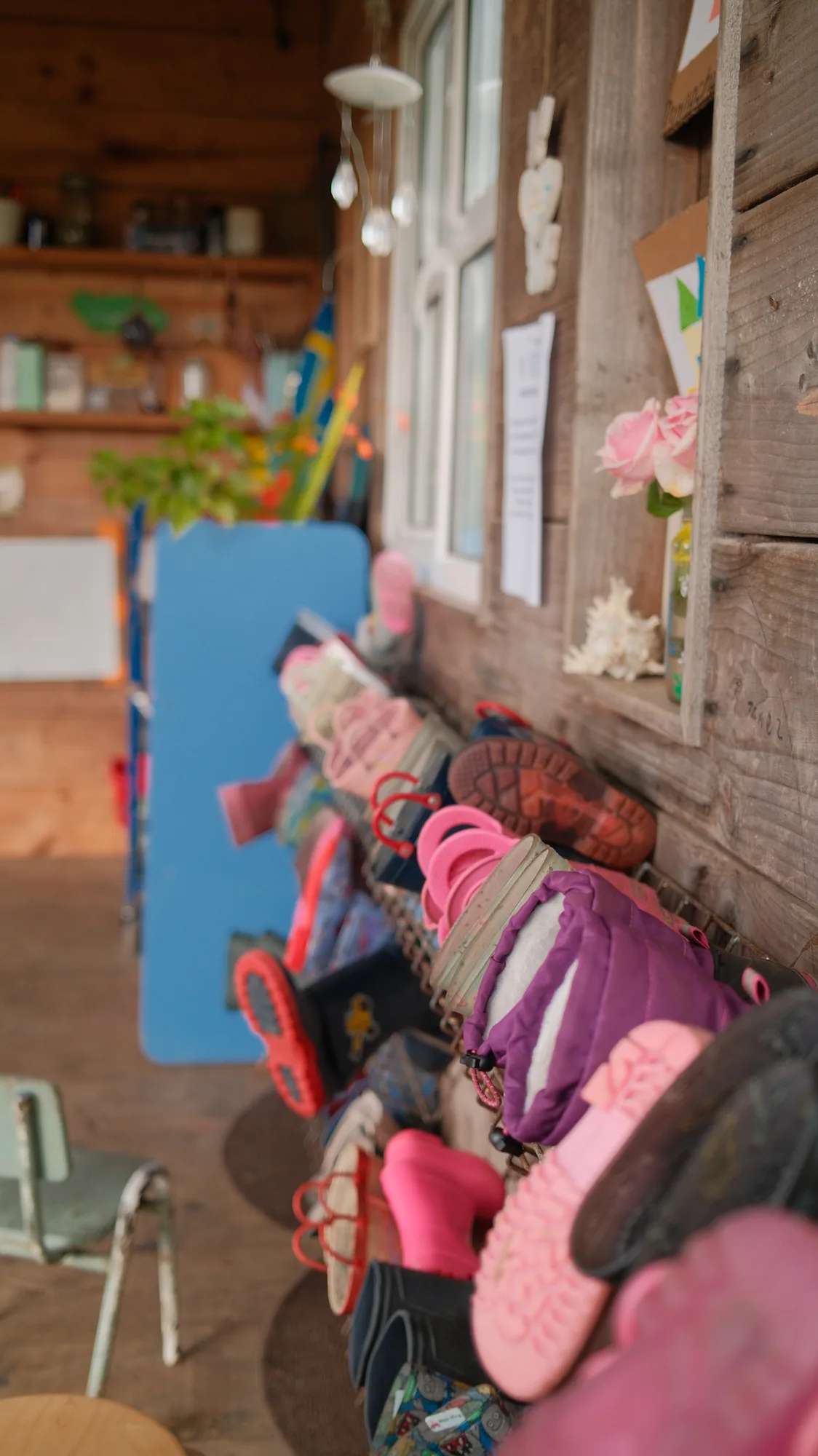 Wellies and hanging materials inside the wooden shelter