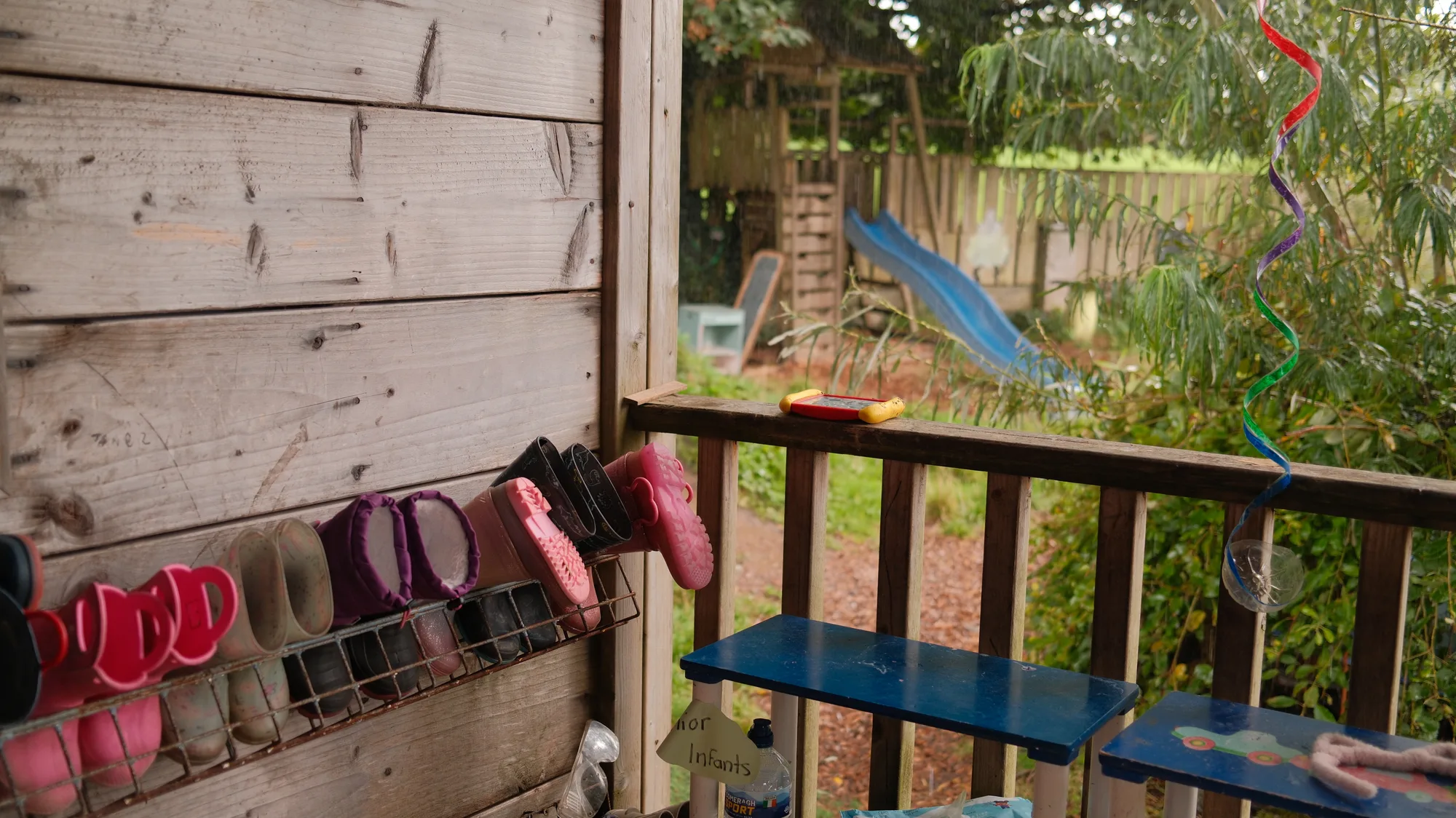 Wellies on the veranda with the slide beyond