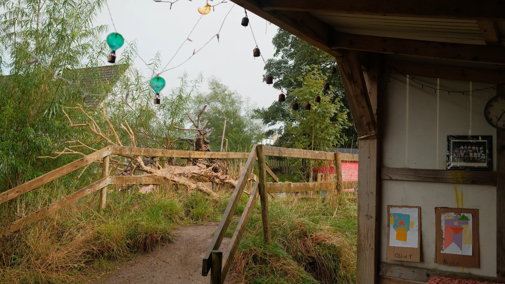Garden structures and plants seen from the wooden shelter