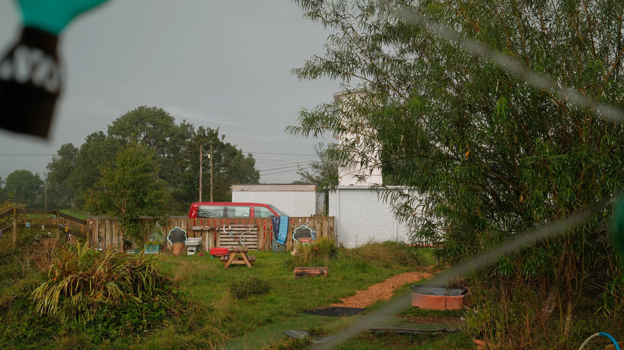 A path leading towards the playhouses across the garden
